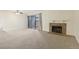 Carpeted living room with stone fireplace and sliding door to patio at 14190 E Temple Dr # O-04, Aurora, CO 80015