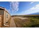 Wide backyard featuring a pergola-covered patio, a sidewalk, and a grassy area with a fence at 11595 Pass Me By Rd, Strasburg, CO 80136