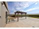 Backyard featuring a pergola-covered patio, and a view of a grass field at 11595 Pass Me By Rd, Strasburg, CO 80136