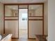 Modern bathroom view into closet with granite countertops at 11595 Pass Me By Rd, Strasburg, CO 80136