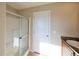 Cozy bathroom with a glass door shower and granite countertop sink at 11595 Pass Me By Rd, Strasburg, CO 80136