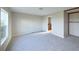Spacious carpeted bedroom with a large window and an ensuite bathroom entrance at 11595 Pass Me By Rd, Strasburg, CO 80136