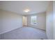 Cozy, carpeted bedroom with an open doorway and a large window with a scenic view at 11595 Pass Me By Rd, Strasburg, CO 80136