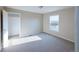Light-filled bedroom with a walk-in closet and a scenic window view at 11595 Pass Me By Rd, Strasburg, CO 80136