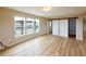 Bright bedroom featuring wood laminate flooring, ample natural light, and sliding door closet at 11595 Pass Me By Rd, Strasburg, CO 80136
