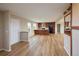 Open-concept kitchen featuring wood cabinets, stainless steel appliances, and wood laminate flooring at 11595 Pass Me By Rd, Strasburg, CO 80136