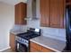 Well-equipped kitchen featuring wood cabinetry, stainless steel appliances, and light countertops at 11595 Pass Me By Rd, Strasburg, CO 80136
