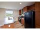 Well-equipped kitchen with stainless steel appliances, wood cabinets, and laminate floors at 11595 Pass Me By Rd, Strasburg, CO 80136