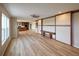 Spacious living room boasts wood laminate flooring, ceiling fan, large windows, and built-in bench at 11595 Pass Me By Rd, Strasburg, CO 80136