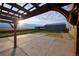 Concrete patio with pergola and view of metal outbuilding; pasture and open space are in the distance at 11595 Pass Me By Rd, Strasburg, CO 80136