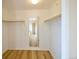 Large walk-in closet with wood floor and a mirror at 11595 Pass Me By Rd, Strasburg, CO 80136