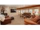 Spacious living room with leather sofas and wood beams at 28268 Shadow Mountain Dr, Conifer, CO 80433