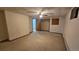Finished basement featuring neutral carpet, baseboard trim, closet, and access to another room at 2840 Wagner St, Strasburg, CO 80136