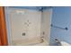 Bathroom featuring white tiled walls, bath tub and shower at 2840 Wagner St, Strasburg, CO 80136
