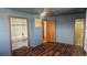 Bedroom with open closet, and view into ensuite bathroom at 2840 Wagner St, Strasburg, CO 80136
