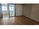 Bright bedroom with hardwood floors, sliding glass doors, and ample natural light at 2840 Wagner St, Strasburg, CO 80136