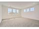 Expansive carpeted bedroom featuring neutral walls, recessed lighting, and multiple windows at 635 Twilight St, Erie, CO 80516