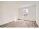 Light-filled bedroom featuring neutral paint, hardwood floors, modern trim, and a window at 635 Twilight St, Erie, CO 80516
