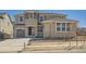 Charming two-story home featuring a stone and siding facade with an attached garage and a well-manicured lawn at 635 Twilight St, Erie, CO 80516