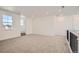 Spacious carpeted loft area with neutral walls, recessed lighting, a staircase, and modern trim at 635 Twilight St, Erie, CO 80516