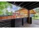Back deck featuring a view of the backyard, wooden privacy fence, and carport at 3429 Avenue D, Kittredge, CO 80457