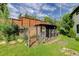 A backyard featuring a custom chicken coop and lush landscaping with mature trees at 3429 Avenue D, Kittredge, CO 80457