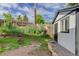 View of a backyard featuring a modern shed with a black door, gravel bed, and a fire pit at 3429 Avenue D, Kittredge, CO 80457