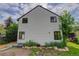 View of backyard and the back of the home with lush landscaping and mature trees at 3429 Avenue D, Kittredge, CO 80457