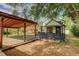 Spacious backyard featuring a large wooden carport, a chicken coop and privacy fence at 3429 Avenue D, Kittredge, CO 80457