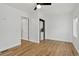 Bright bedroom featuring a ceiling fan, wood floors, and a discreetly placed washer/dryer combo at 3429 Avenue D, Kittredge, CO 80457