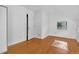 Bright bedroom featuring wood floors, white walls, window and closet for a clean modern design at 3429 Avenue D, Kittredge, CO 80457