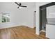 Well-lit bedroom with a ceiling fan and a convenient washer/dryer setup for easy laundry access at 3429 Avenue D, Kittredge, CO 80457