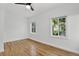 Sunlit bedroom with hardwood floors and dual windows offering ample natural light at 3429 Avenue D, Kittredge, CO 80457