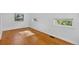Bright bedroom featuring wood floors, white walls and two windows that bring in plenty of natural light at 3429 Avenue D, Kittredge, CO 80457