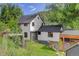 Two-story home with gray roof, private yard, and mature trees provides a beautiful backdrop at 3429 Avenue D, Kittredge, CO 80457