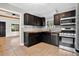 Well-equipped kitchen with stainless appliances, dark cabinets, wood counters, and tile floor at 3429 Avenue D, Kittredge, CO 80457