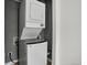 Efficient laundry area featuring a stacked washer and dryer with modern connections and design at 3429 Avenue D, Kittredge, CO 80457