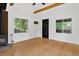 Cozy living room with hardwood floors, wood stove, and plenty of natural light at 3429 Avenue D, Kittredge, CO 80457