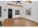 Living room with hardwood floors, exposed ceiling beams, and access to a front door at 3429 Avenue D, Kittredge, CO 80457