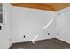 Interior of shed with laminate flooring, white paneled walls, window, and tongue and groove ceiling at 3429 Avenue D, Kittredge, CO 80457