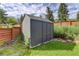 Backyard shed with a gray exterior and a roof that protects from the elements at 3429 Avenue D, Kittredge, CO 80457