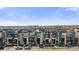Stunning aerial view of modern townhouses, showcasing the city skyline in the distance at 1525 W 68Th Ave, Denver, CO 80221