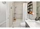Cozy bathroom featuring a combination shower and tub, tile surround and built-in shelving at 1525 W 68Th Ave, Denver, CO 80221