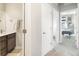 Modern bathroom featuring a sleek vanity, stylish fixtures, and a convenient towel rack near the shower at 1525 W 68Th Ave, Denver, CO 80221