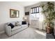 Light and airy secondary bedroom featuring a comfortable sofa and large window at 1525 W 68Th Ave, Denver, CO 80221