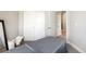 Bright bedroom featuring neutral-toned walls, comfortable massage bed, and sliding closet doors at 1525 W 68Th Ave, Denver, CO 80221