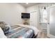 Cozy bedroom with a mounted TV, neutral walls, and a window with coverings at 1525 W 68Th Ave, Denver, CO 80221