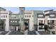 Striking exterior view of modern townhouses boasting multiple windows, balconies, and unique color schemes at 1525 W 68Th Ave, Denver, CO 80221