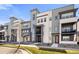 Modern townhome exterior showcasing a contemporary design and well-maintained landscaping at 1525 W 68Th Ave, Denver, CO 80221