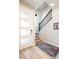 Bright foyer features wood floors, a modern light fixture, and a staircase at 1525 W 68Th Ave, Denver, CO 80221
